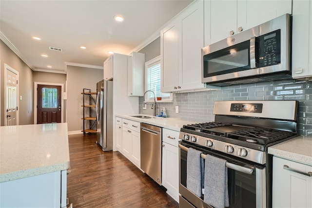 kitchen with white cabinetry, appliances with stainless steel finishes, sink, and light stone counters