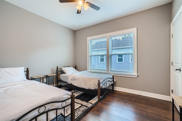 bedroom with dark wood-type flooring and ceiling fan