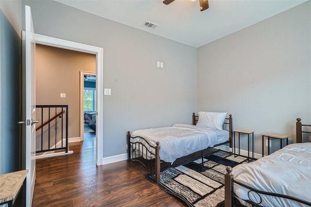 bedroom with ceiling fan and dark hardwood / wood-style floors