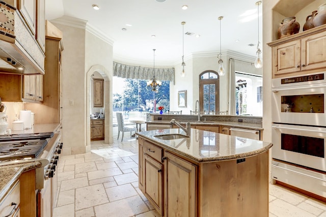 kitchen with an island with sink, sink, pendant lighting, and double oven