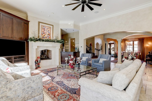 living room featuring crown molding, decorative columns, and ceiling fan