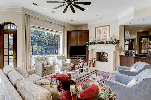 living room with ceiling fan and ornamental molding