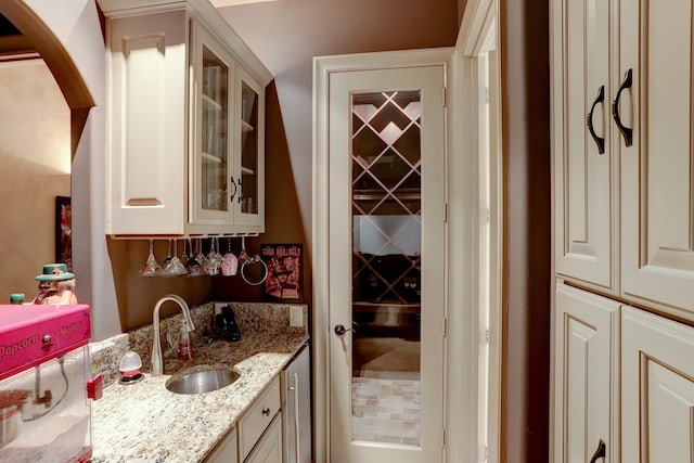 bar with light stone counters and sink