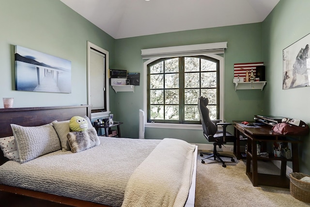 bedroom featuring lofted ceiling and carpet flooring