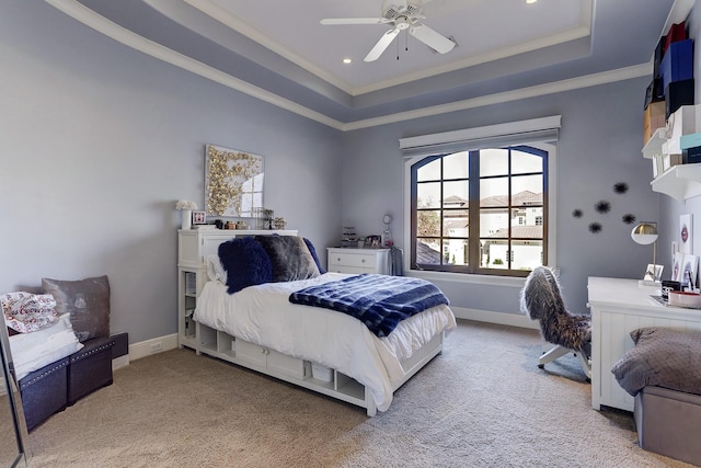 bedroom featuring ceiling fan, ornamental molding, carpet flooring, and a raised ceiling