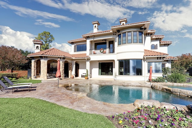 back of property with a patio and a balcony