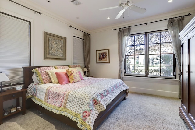 bedroom with light carpet, ornamental molding, and ceiling fan