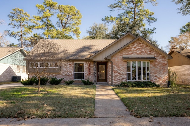 ranch-style house with central air condition unit and a front lawn