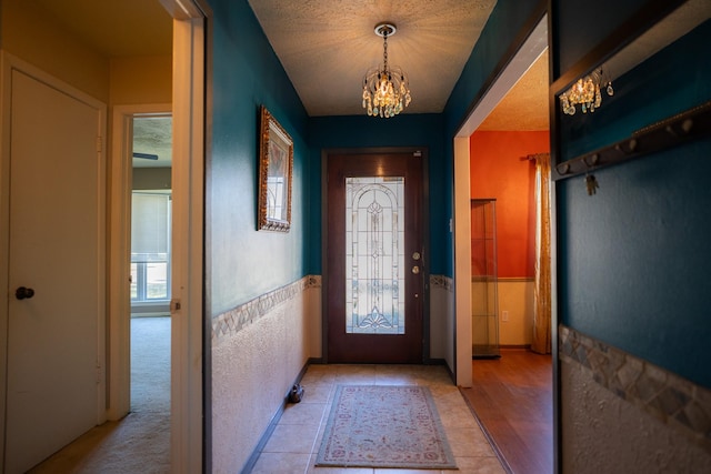 foyer with plenty of natural light and a chandelier