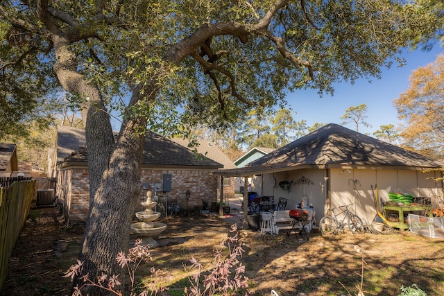 rear view of property featuring central AC unit