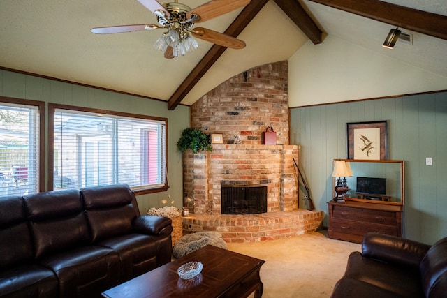 carpeted living room featuring ceiling fan, a fireplace, and vaulted ceiling with beams