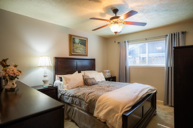 bedroom featuring ceiling fan, light carpet, and a textured ceiling