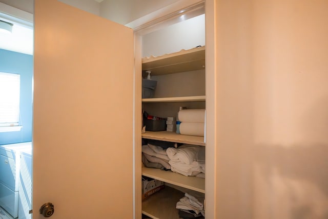 closet with washer and clothes dryer