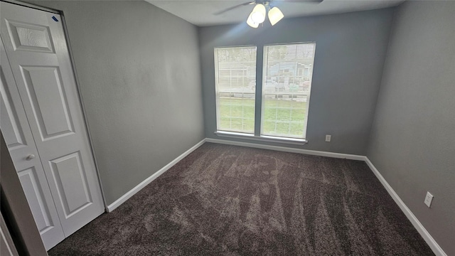 carpeted empty room featuring a wealth of natural light and ceiling fan