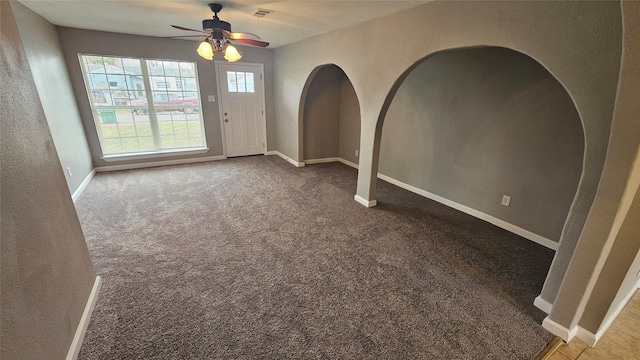 interior space with ceiling fan and carpet flooring