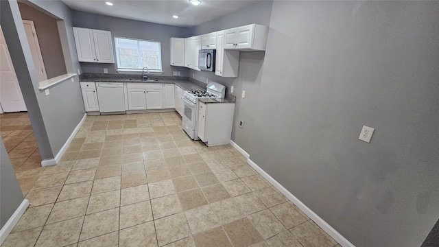 kitchen with white cabinetry, white appliances, and sink