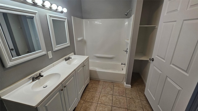 bathroom with washtub / shower combination, tile patterned floors, and vanity