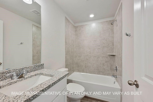 full bathroom with vanity, toilet, and tiled shower / bath