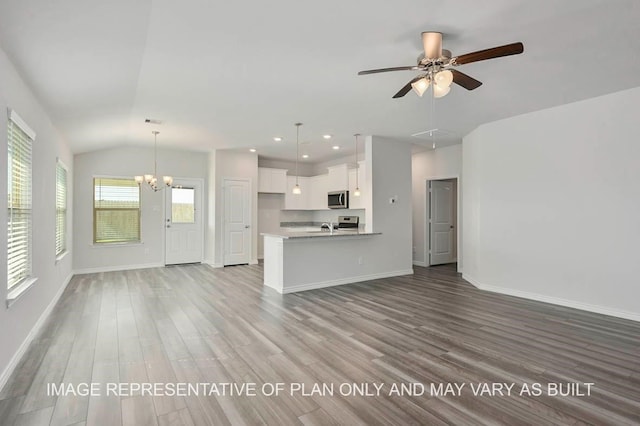 unfurnished living room featuring ceiling fan with notable chandelier, lofted ceiling, sink, and light hardwood / wood-style floors