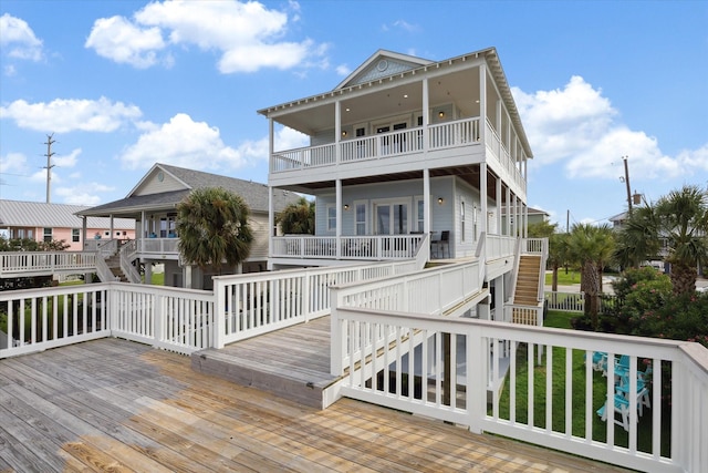 wooden terrace featuring a lawn