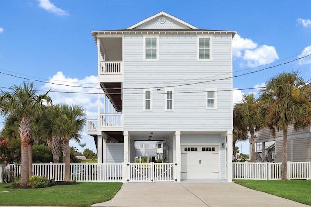 coastal inspired home with a garage, a balcony, and a front yard