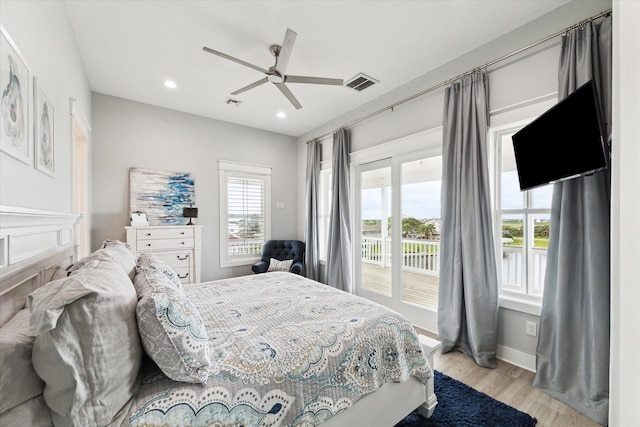 bedroom featuring access to exterior, light hardwood / wood-style flooring, and ceiling fan