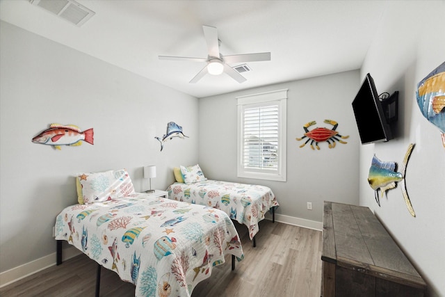 bedroom with ceiling fan and light hardwood / wood-style floors