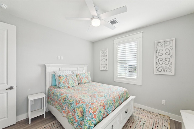 bedroom with hardwood / wood-style floors and ceiling fan