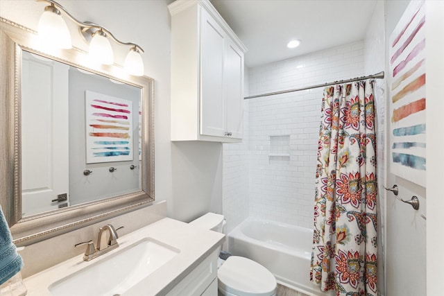 full bathroom with vanity, shower / tub combo, and toilet