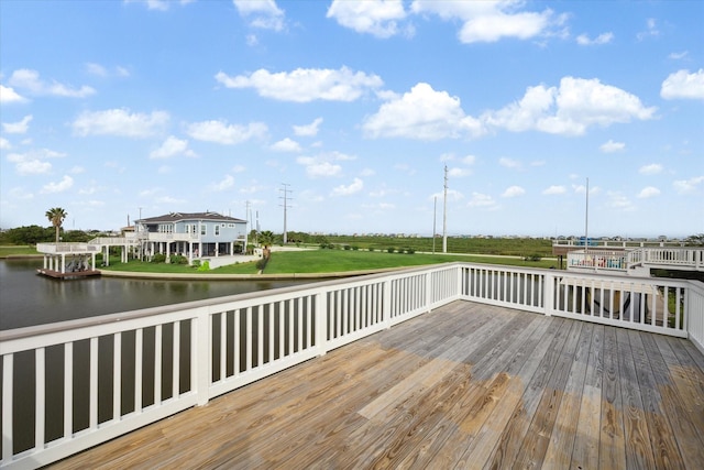 wooden terrace featuring a water view