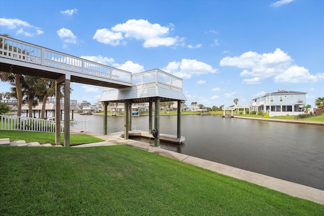 view of dock featuring a water view and a yard