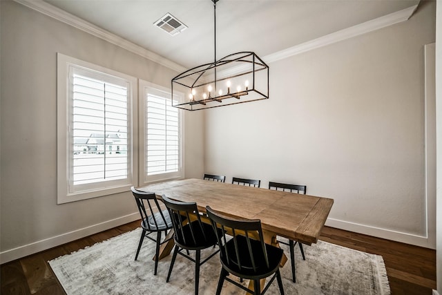 dining room featuring crown molding, a healthy amount of sunlight, and dark hardwood / wood-style floors