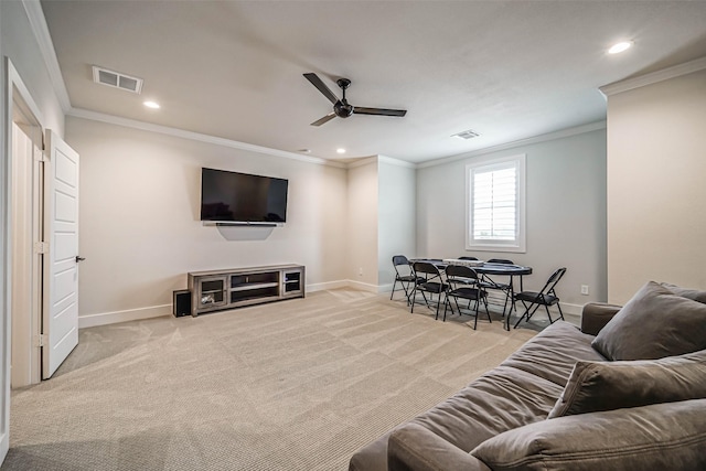 carpeted living room with crown molding and ceiling fan