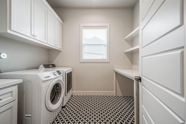 laundry area featuring cabinets and washer and clothes dryer