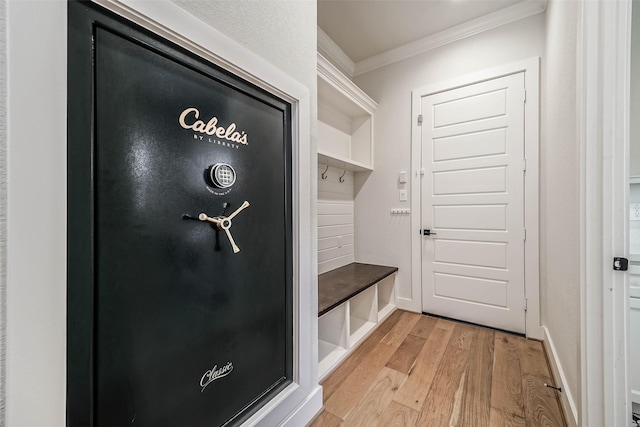 mudroom with ornamental molding and light wood-type flooring