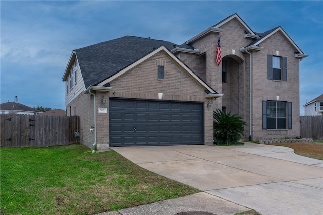 view of front property featuring a garage and a front lawn