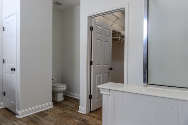 bathroom featuring hardwood / wood-style floors and toilet