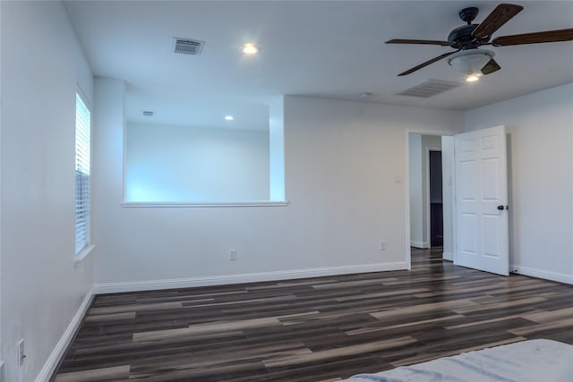 unfurnished room with dark hardwood / wood-style floors and ceiling fan