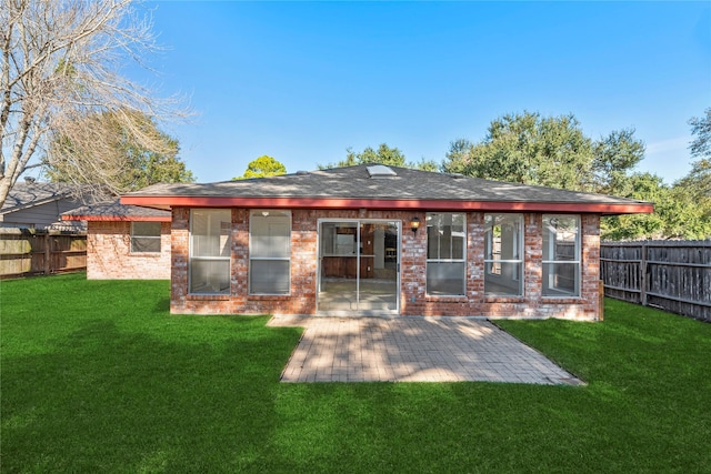 back of house with a patio and a lawn