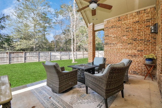 view of patio with a fire pit and ceiling fan