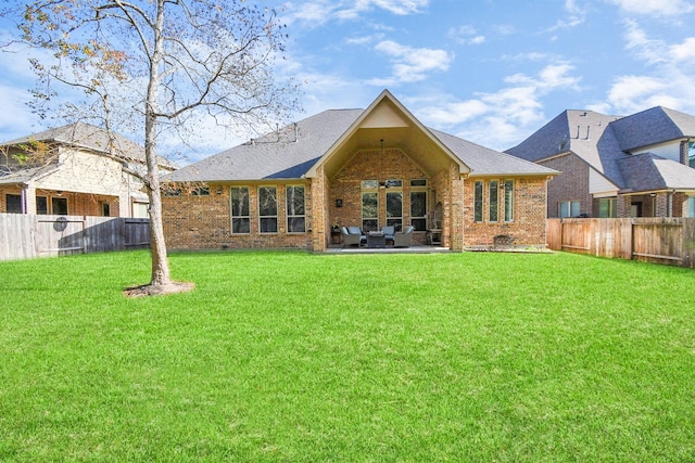 back of property featuring a patio and a lawn