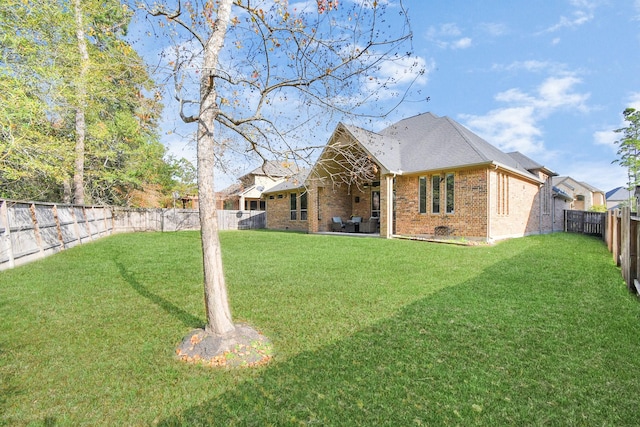 rear view of house with a yard