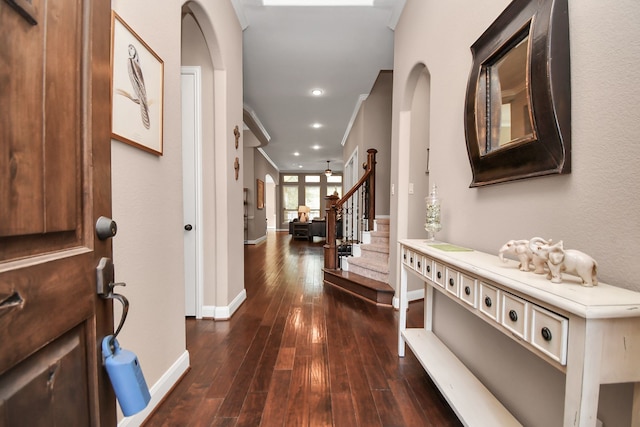 hall featuring ornamental molding and dark hardwood / wood-style floors