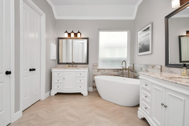 bathroom with a bathing tub, vaulted ceiling, tile walls, and vanity