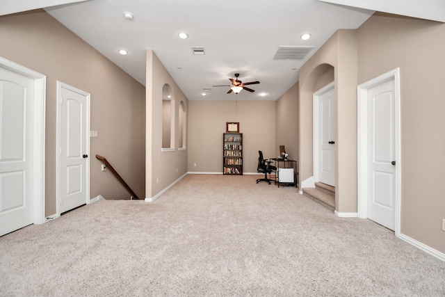 interior space with ceiling fan and light carpet