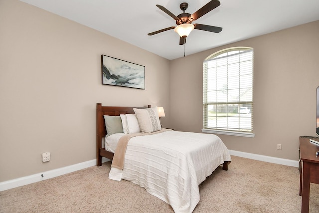 bedroom with ceiling fan and light carpet