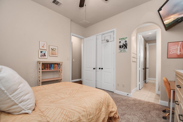 bedroom with light carpet, a closet, and ceiling fan