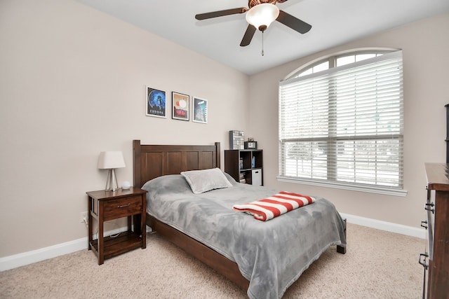 carpeted bedroom with multiple windows and ceiling fan