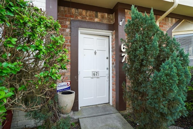 property entrance with brick siding