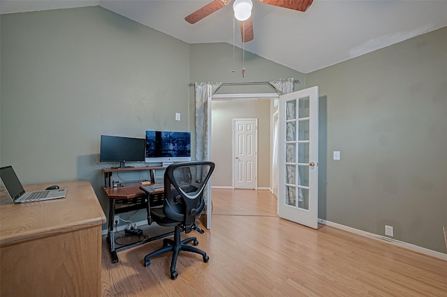 office space featuring ceiling fan, lofted ceiling, and light wood-type flooring